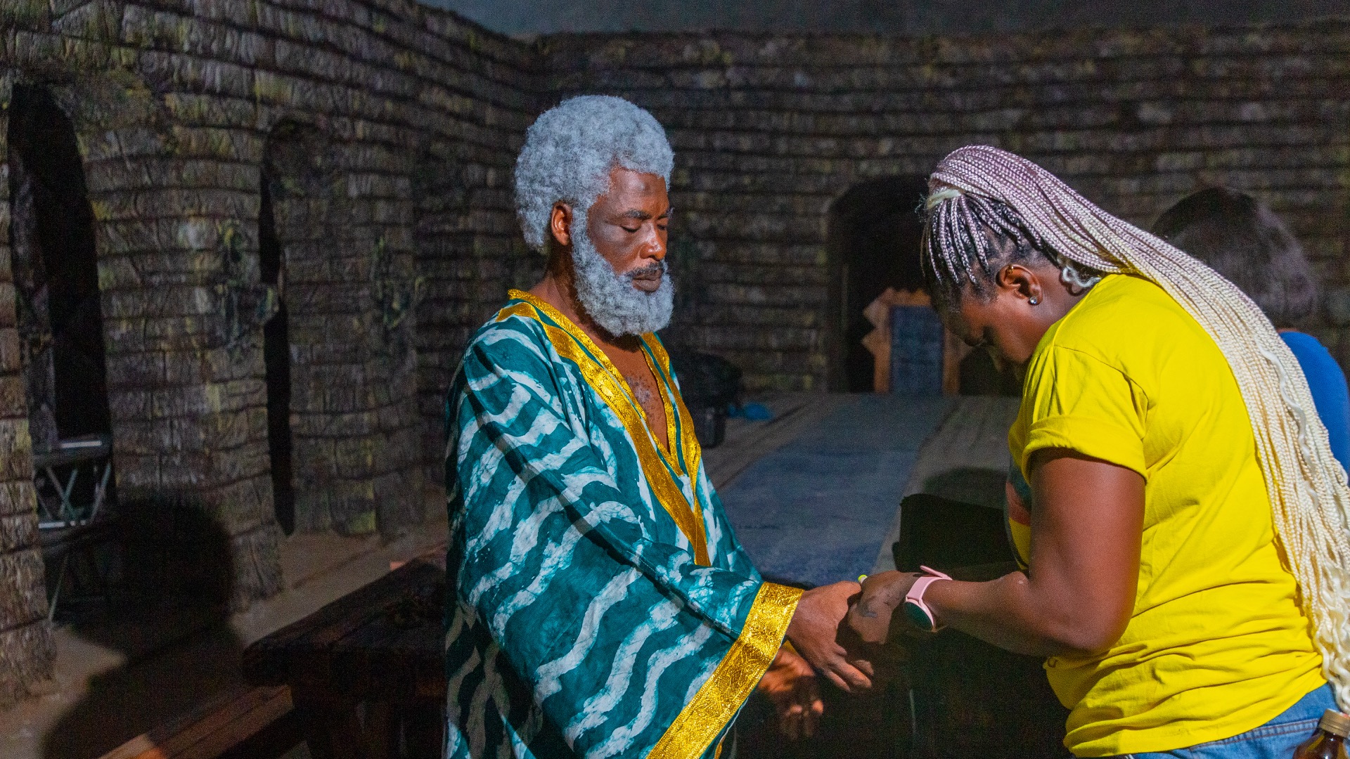 Udu Alakpa on What It Really Takes to Do Makeup on Film Sets 7 Udu Alakpa paints Ibrahim Chatta's nails on the set of 'Colours of Fire' © Anthill Studios - Nollywire