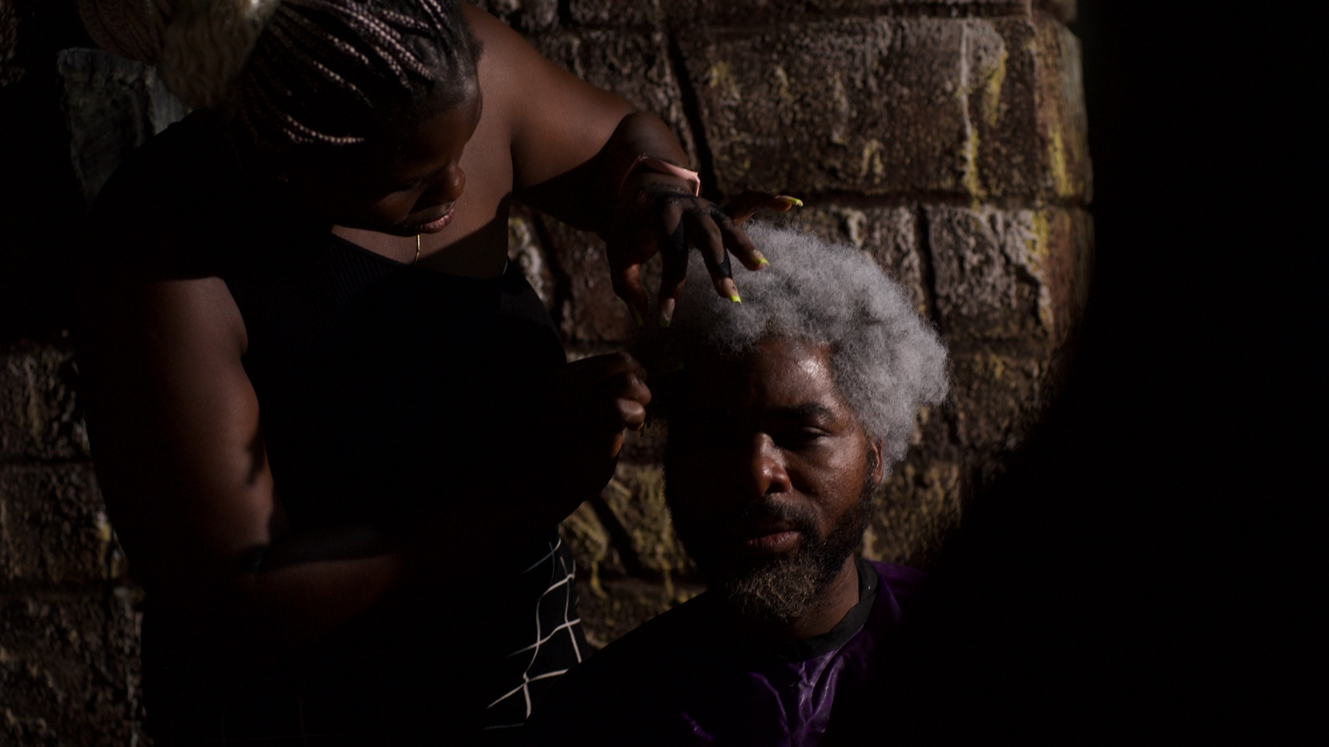 Udu Alakpa on What It Really Takes to Do Makeup on Film Sets 6 Udu Alakpa sets Ibrahim Chatta's hair on the set of 'Colours of Fire' © Anthill Studios - Nollywire 2