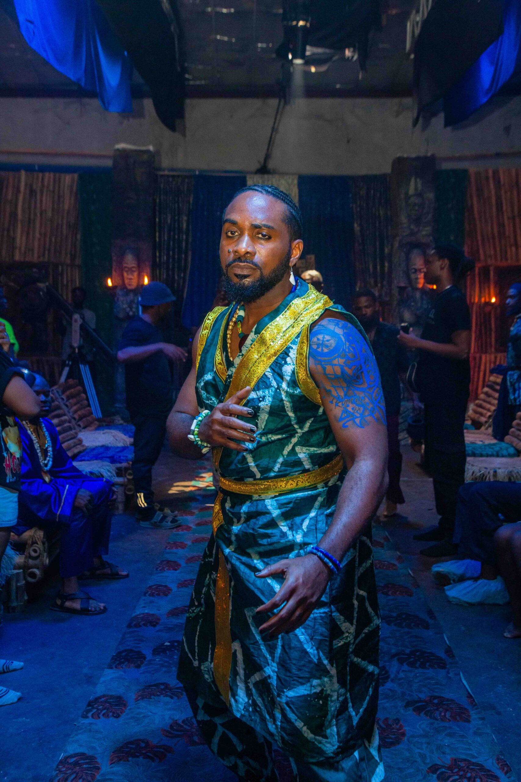 Udu Alakpa on What It Really Takes to Do Makeup on Film Sets 9 Uzor Arukwe with tatoos on the set of 'Colours of Fire' © Anthill Studios - Nollywire